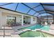 Outdoor covered lanai with pool, spa, and dining area at 27124 Capri Shores Cir, Englewood, FL 34223