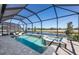 Screened-in pool and spa with tranquil water view at 27124 Capri Shores Cir, Englewood, FL 34223