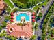 Aerial of the pool area with cabanas, lounge chairs, and meticulous landscaping at 2733 Via Cipriani # 830B, Clearwater, FL 33764