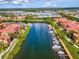 Scenic aerial view of waterfront condos with private boat docks, amidst lush landscaping and waterways at 2733 Via Cipriani # 830B, Clearwater, FL 33764