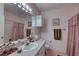 Cozy bathroom with a large mirror, tile flooring, and neutral color palette at 2733 Via Cipriani # 830B, Clearwater, FL 33764