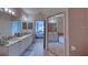 Well-appointed bathroom with dual sinks, elegant fixtures, and a mirrored closet adjacent to the main bedroom at 2733 Via Cipriani # 830B, Clearwater, FL 33764