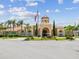 Beautiful clubhouse with a grand entrance, manicured landscaping, and a golf cart at 2733 Via Cipriani # 830B, Clearwater, FL 33764
