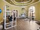 Spacious fitness center with modern weight machines, mirrored walls, and wood flooring at 2733 Via Cipriani # 830B, Clearwater, FL 33764