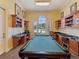 Inviting game room with a billiard table, built-in shelving, and cozy seating, perfect for entertainment at 2733 Via Cipriani # 830B, Clearwater, FL 33764