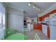 Eat-in kitchen featuring wood cabinets, modern appliances, and a view to a comfortable living area at 2733 Via Cipriani # 830B, Clearwater, FL 33764