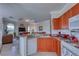 Open kitchen view showcasing granite counters, modern appliances, and seamless flow into the adjacent living area at 2733 Via Cipriani # 830B, Clearwater, FL 33764