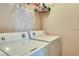 Practical laundry area featuring a side-by-side washer and dryer and wire shelving for storage at 2733 Via Cipriani # 830B, Clearwater, FL 33764