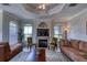 Comfortable living room with fireplace, plush seating, and arched windows for natural light at 2733 Via Cipriani # 830B, Clearwater, FL 33764