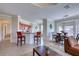 Bright open-concept living room with tile flooring, modern furnishings, and a breakfast bar adjacent to the kitchen at 2733 Via Cipriani # 830B, Clearwater, FL 33764