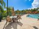 Beautiful pool area featuring comfortable seating and dining tables, perfect for relaxing and socializing at 2733 Via Cipriani # 830B, Clearwater, FL 33764