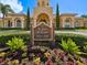 Villa d'Este sign surrounded by manicured landscaping with the community building in the background at 2733 Via Cipriani # 830B, Clearwater, FL 33764