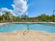 Sparkling swimming pool with lounge chairs, umbrellas, and clear blue water, perfect for relaxation and recreation at 2733 Via Cipriani # 830B, Clearwater, FL 33764