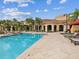 Inviting swimming pool with a volleyball net, surrounded by lounge seating and lush landscaping at 2733 Via Cipriani # 830B, Clearwater, FL 33764