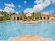 Resort-style pool area showcasing a large pool, island seating, and a Mediterranean-style clubhouse at 2733 Via Cipriani # 830B, Clearwater, FL 33764