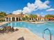 Resort-style pool area with lounge chairs and palm trees, perfect for relaxation at 2733 Via Cipriani # 830B, Clearwater, FL 33764