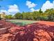 Well maintained tennis court surrounded by lush landscaping, perfect for recreational play and fitness at 2733 Via Cipriani # 830B, Clearwater, FL 33764