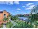 Balcony view of waterway, offering a serene landscape with lush greenery and docked boats at 2733 Via Cipriani # 830B, Clearwater, FL 33764