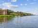 Stunning waterfront condos with boat docks, lush landscaping and tranquil water views under a sunny sky at 2733 Via Cipriani # 830B, Clearwater, FL 33764