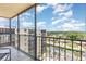 Expansive balcony overlooking the neighborhood with parking and tree views on a sunny day at 2901 26Th W St # 815, Bradenton, FL 34205