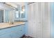 Well-lit bathroom with dual mirrors, tiled backsplash, and a spacious closet for storage at 2901 26Th W St # 815, Bradenton, FL 34205