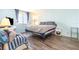Cozy bedroom featuring a comfortable bed, light blue walls, natural lighting from the window, and wood-look floors at 2901 26Th W St # 815, Bradenton, FL 34205