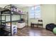 Efficient bedroom showcasing a bunk bed, window for natural light, and laminate flooring at 2901 26Th W St # 815, Bradenton, FL 34205