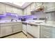 Well-lit kitchen featuring white appliances, wooden cabinets, stone counter tops, and a modern light fixture at 2901 26Th W St # 815, Bradenton, FL 34205