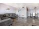 Spacious living room with a gray sofa, wood-look floors, and an open concept layout with view of dining area at 2901 26Th W St # 815, Bradenton, FL 34205