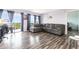 Living room with a large gray sofa, wood floors, a sliding glass door, and an office area with views at 2901 26Th W St # 815, Bradenton, FL 34205