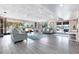 A bright lobby has large windows, light gray wood-like flooring, and matching furniture at 2901 26Th W St # 815, Bradenton, FL 34205