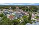 Residential neighborhood aerial view featuring a gray two-story home with a charming brick driveway at 3013 W Crest Ave, Tampa, FL 33614