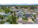 Aerial view of a home with a gray exterior and brick driveway nestled among other houses in a community at 3013 W Crest Ave, Tampa, FL 33614