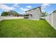 Spacious fenced backyard showcasing a well-manicured lawn, ideal for Gathering gatherings and outdoor enjoyment at 3013 W Crest Ave, Tampa, FL 33614