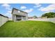 Expansive backyard featuring lush green lawn and a covered patio, perfect for outdoor entertaining and relaxation at 3013 W Crest Ave, Tampa, FL 33614