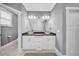 Bathroom featuring a double sink vanity with vessel sinks, framed mirrors, and white cabinets at 3013 W Crest Ave, Tampa, FL 33614