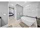 This bathroom features a soaking tub, gray walls, and leads to the primary bedroom at 3013 W Crest Ave, Tampa, FL 33614