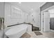 Bathroom featuring a freestanding tub, walk-in shower, and white subway tile at 3013 W Crest Ave, Tampa, FL 33614