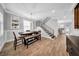 Bright dining room with wood floors, stylish chandelier, built-in shelves, and an adjacent staircase to the upper level at 3013 W Crest Ave, Tampa, FL 33614