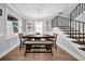 Elegant dining room with built-in shelving, modern lighting, and a staircase, creating a welcoming space for meals at 3013 W Crest Ave, Tampa, FL 33614