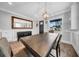 Spacious dining room with wood flooring, an oversized mirror, contemporary lighting, and ample seating at 3013 W Crest Ave, Tampa, FL 33614