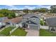 Charming two-story home with a gray exterior, a well-kept yard, and a patterned brick driveway at 3013 W Crest Ave, Tampa, FL 33614