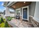 Inviting front porch features stone accents, elegant seating, and a wood ceiling, creating a cozy outdoor space at 3013 W Crest Ave, Tampa, FL 33614