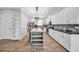 Bright kitchen features white cabinets, stainless appliances, and a stylish center island with seating at 3013 W Crest Ave, Tampa, FL 33614