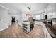 Open kitchen showcases white cabinetry, stainless appliances, stone backsplash, and an island with barstool seating at 3013 W Crest Ave, Tampa, FL 33614