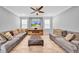Spacious living room with wood-look tile flooring, comfortable sofas, and an entertainment center at 3013 W Crest Ave, Tampa, FL 33614