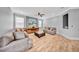 Cozy living room with neutral tones, wood-look tile flooring, modern lighting, and comfortable seating at 3013 W Crest Ave, Tampa, FL 33614