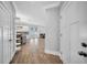 Open-concept living space with hardwood floors seamlessly connects the kitchen, dining, and Gathering areas at 3013 W Crest Ave, Tampa, FL 33614