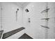 This shower features white subway tile, a bench, and glass shelves at 3013 W Crest Ave, Tampa, FL 33614