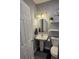 Charming bathroom with pedestal sink, updated fixtures, and decorative shelves at 305 E Adalee St, Tampa, FL 33603
